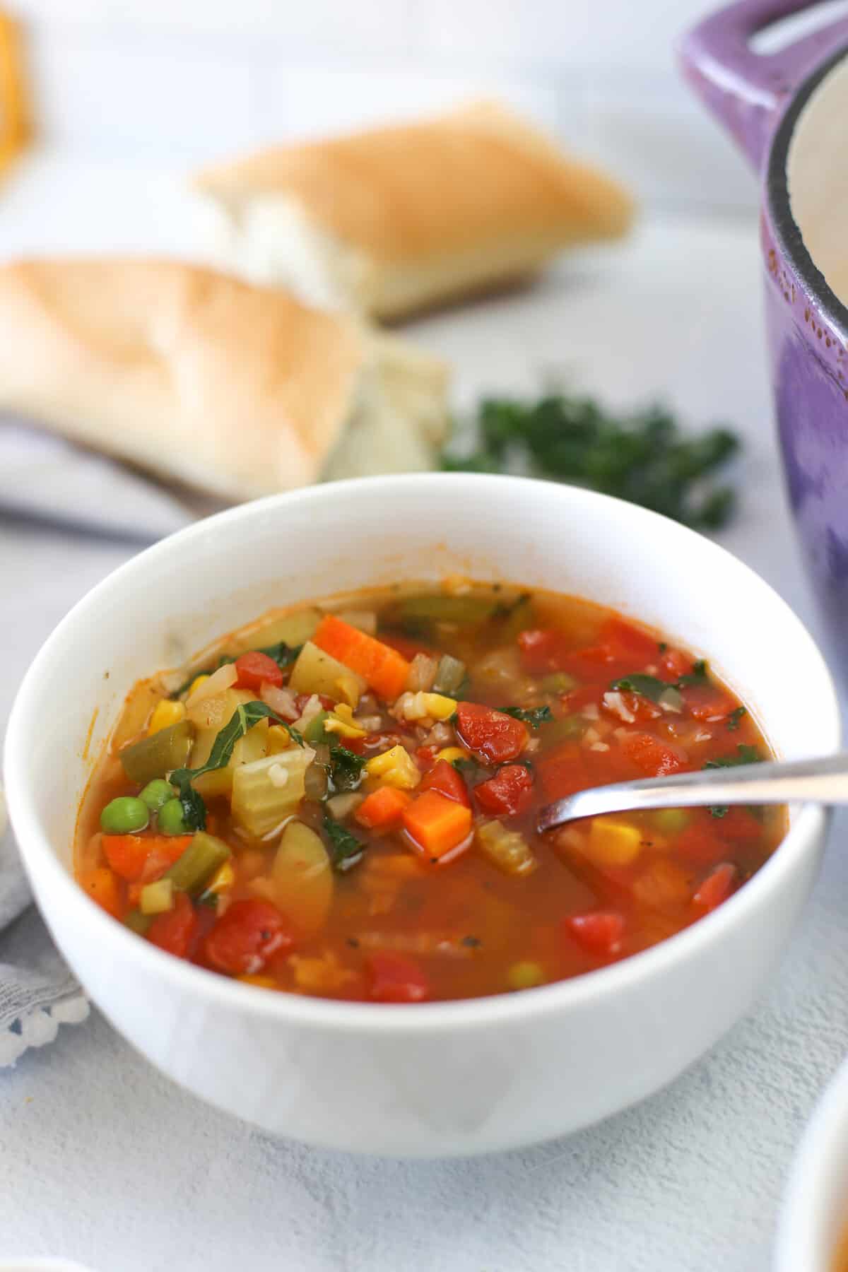 Vegetable soup served in a white bowl.