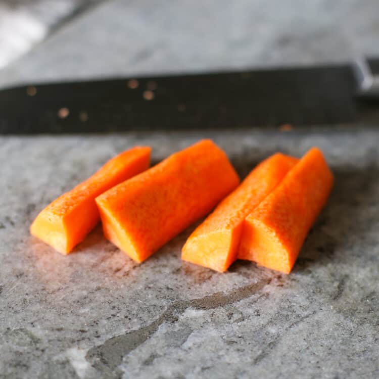 Sliced carrots on a cutting board.