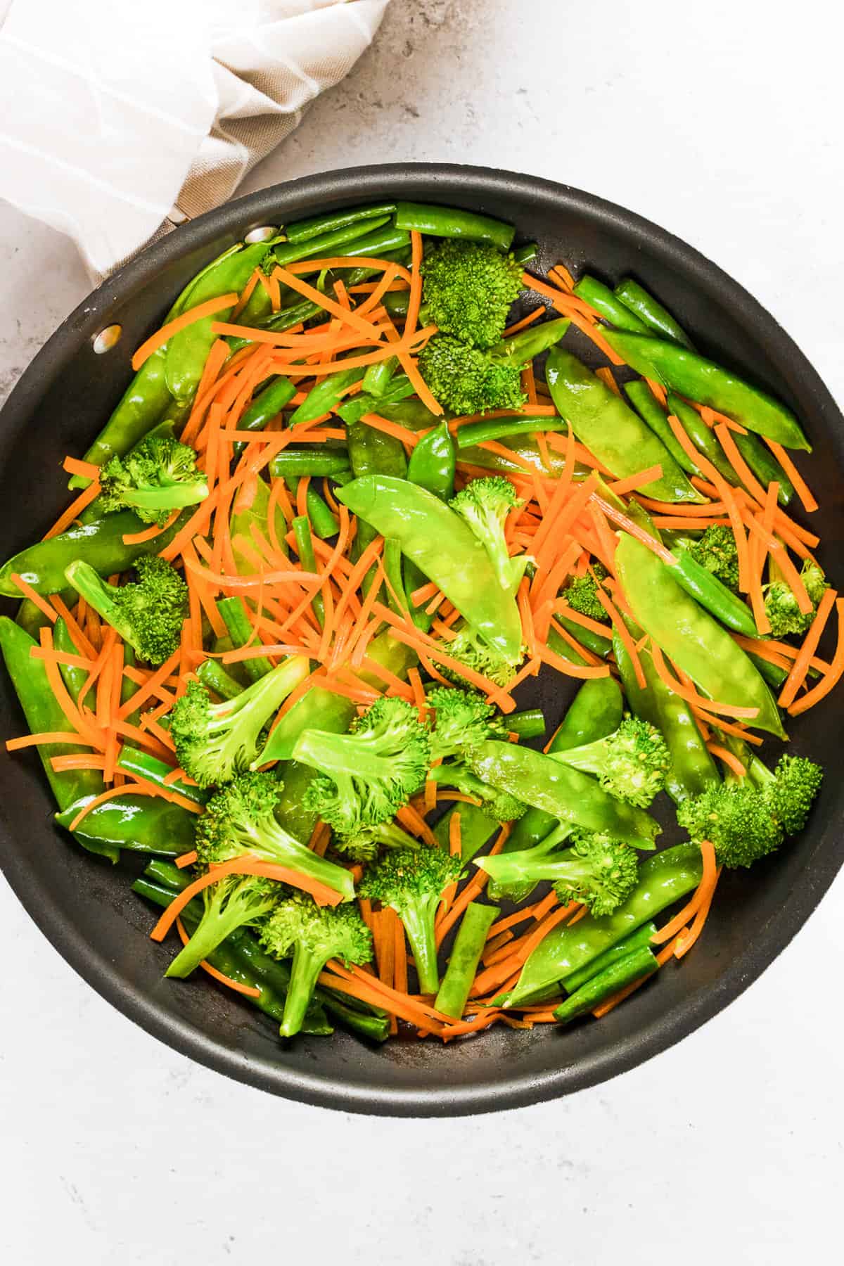 Sautéing veggies in a skillet.