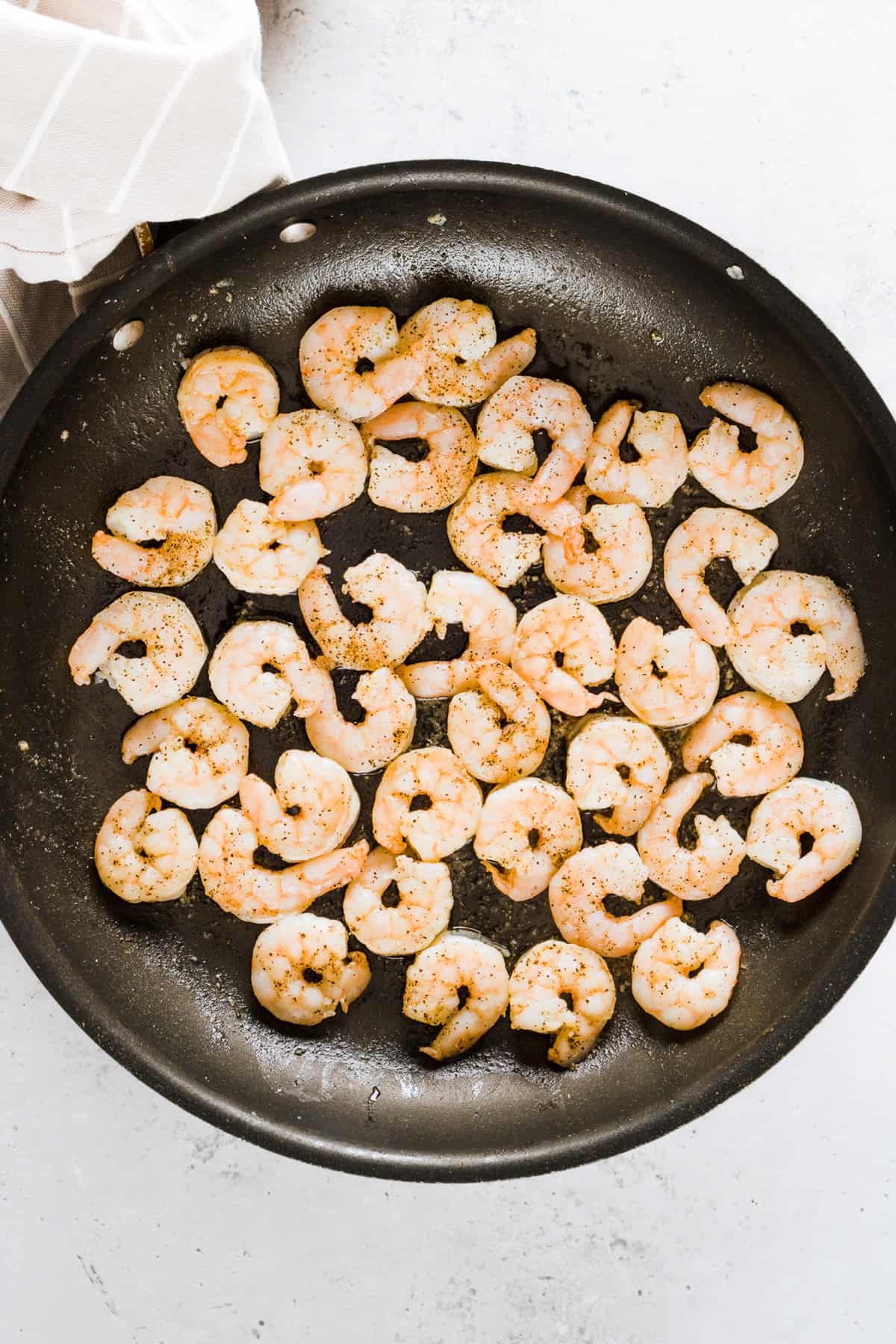 Cooked shrimp in a skillet.