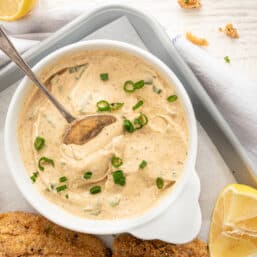 Cajun remoulade sauce in a bowl with fried catfish on the side.