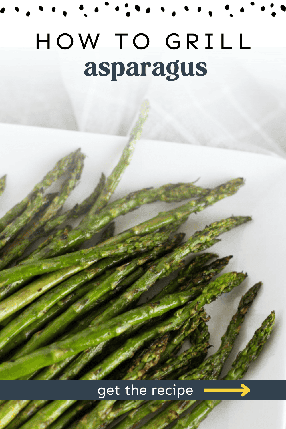 Grilled asparagus served on a white platter.