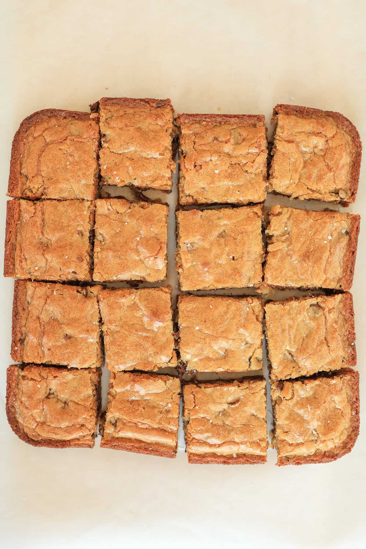 Blondie brownies dumped from a square baking dish and cut into pieces.