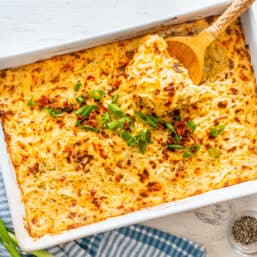 Hashbrown casserole in a white baking dish.