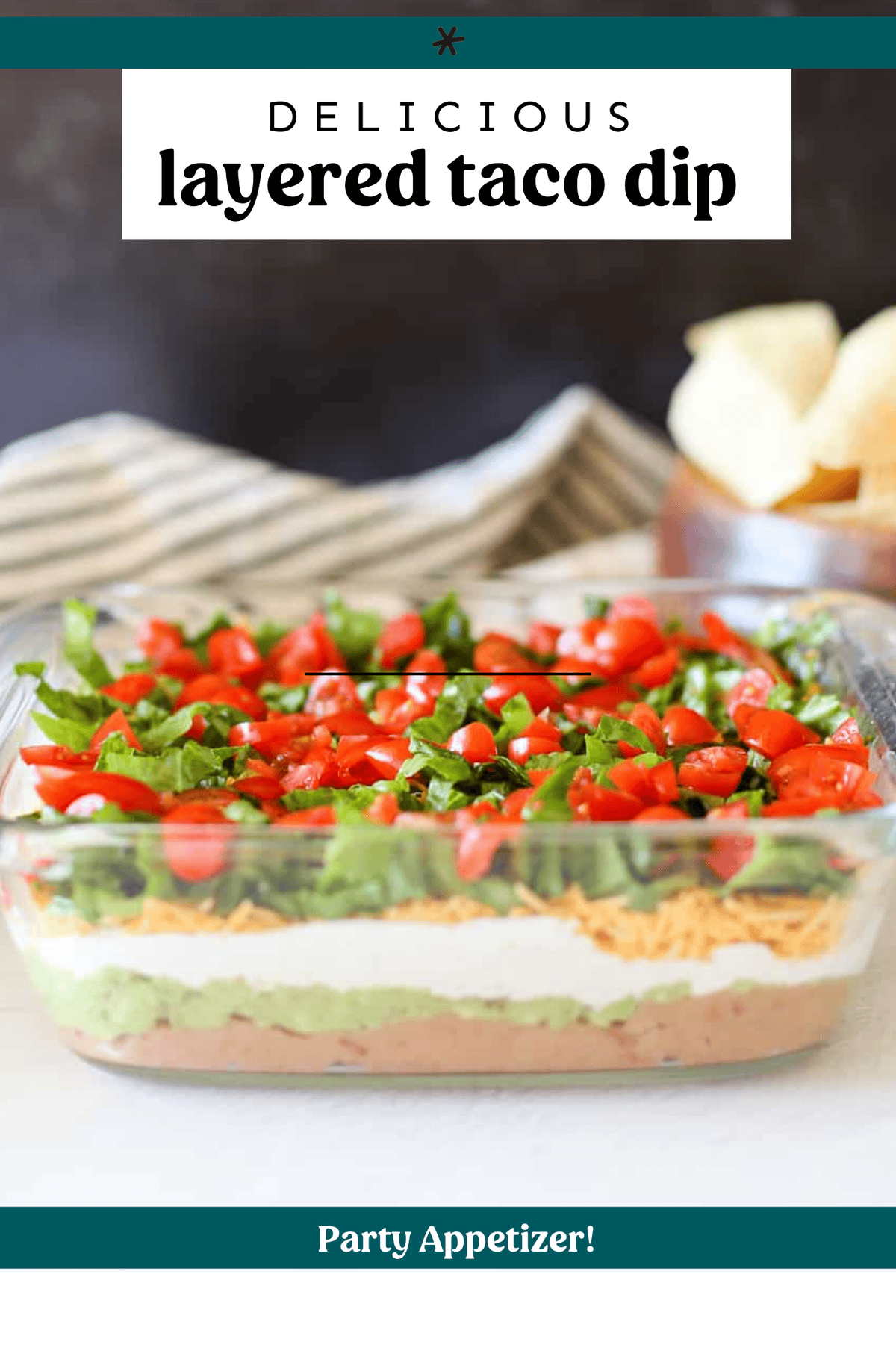 Layered taco dip in a glass baking dish.