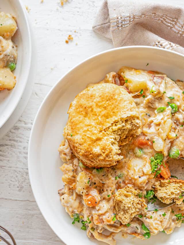 hero shot of chicken pot pie mixture in a bowl with a whole wheat biscuit on top