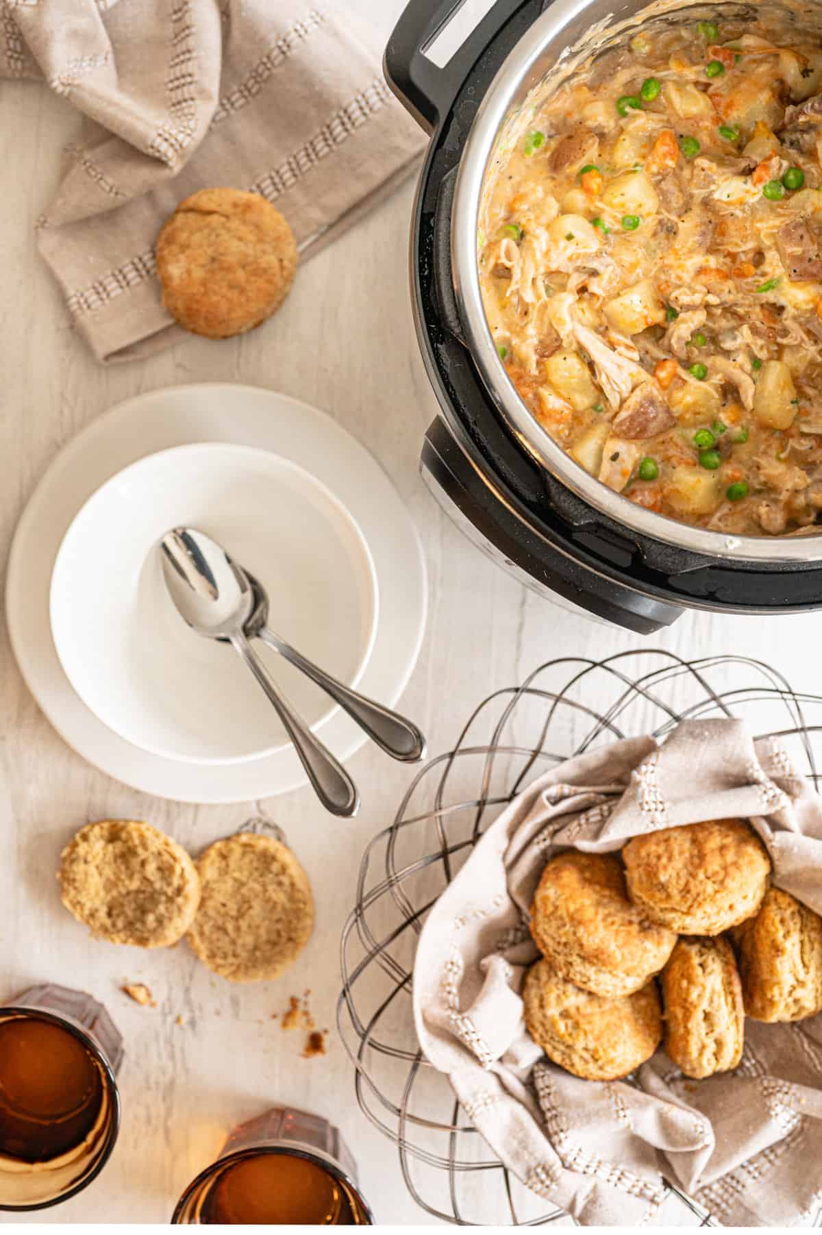 Instant Pot chicken pot pie with a basket of biscuits beside it.