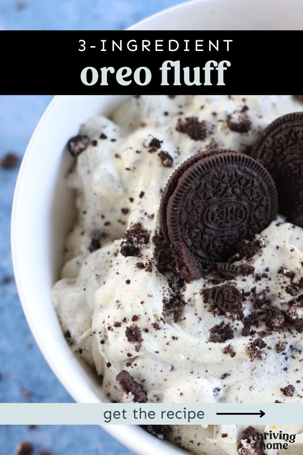 Oreo fluff dessert in a bowl with two whole oreos stuck on top.