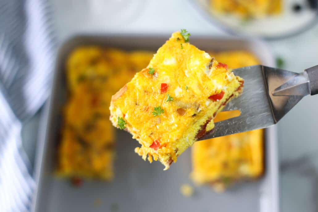 spatula lifting a slice of baked omelette up