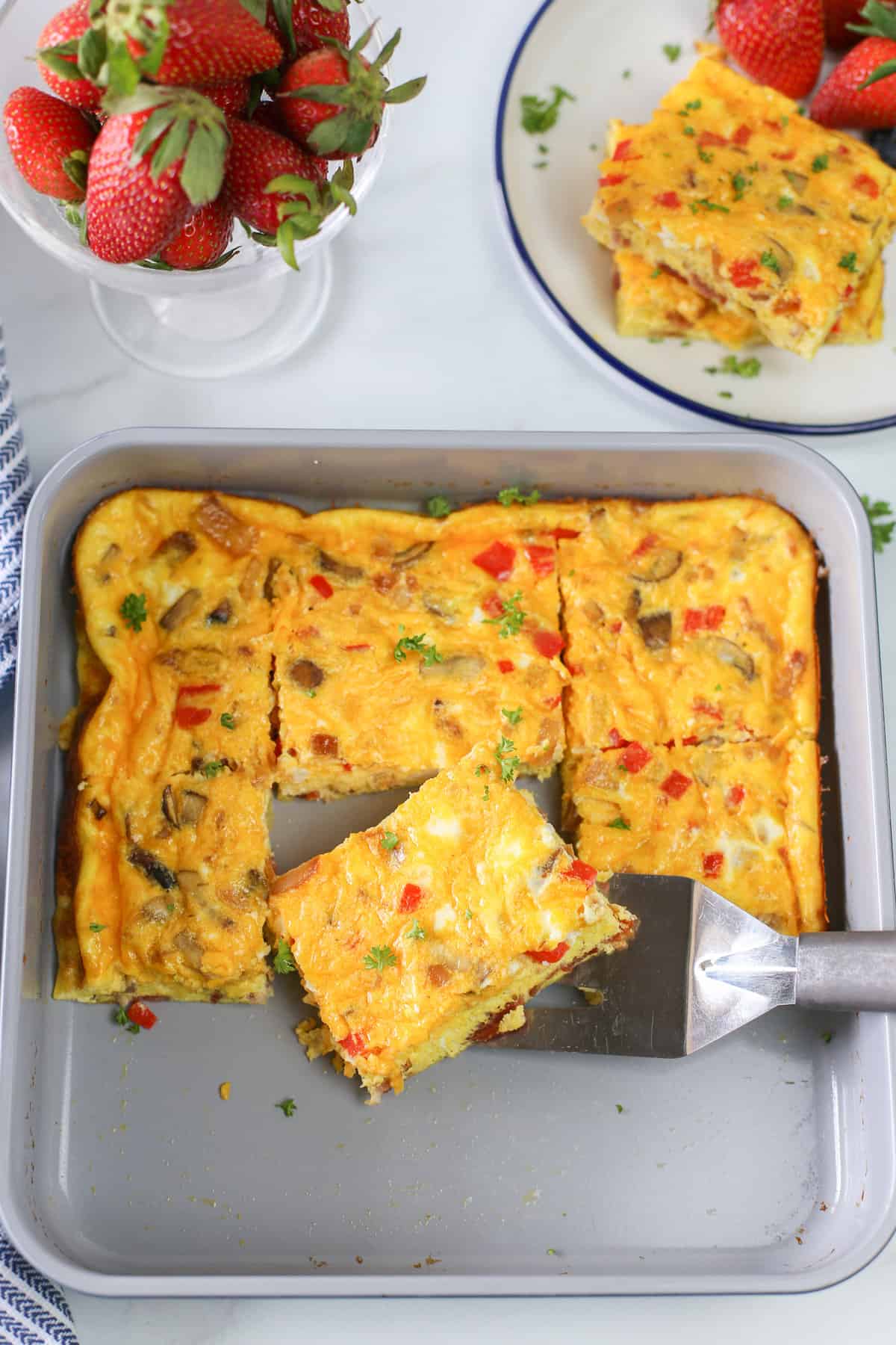 Baked omelette slices in a baking pan.