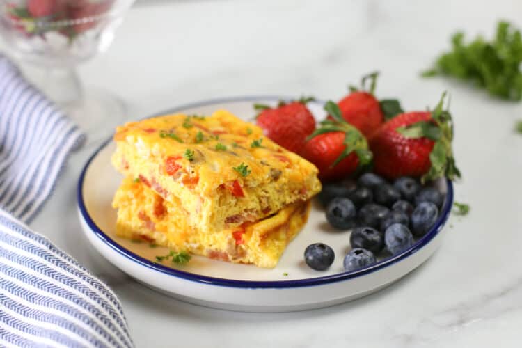 baked omelette on a plate with strawberries and blueberries