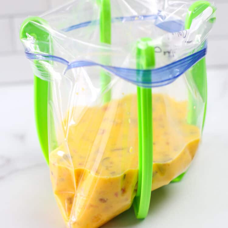 freezer bag stand holding a bag of omelette batter.