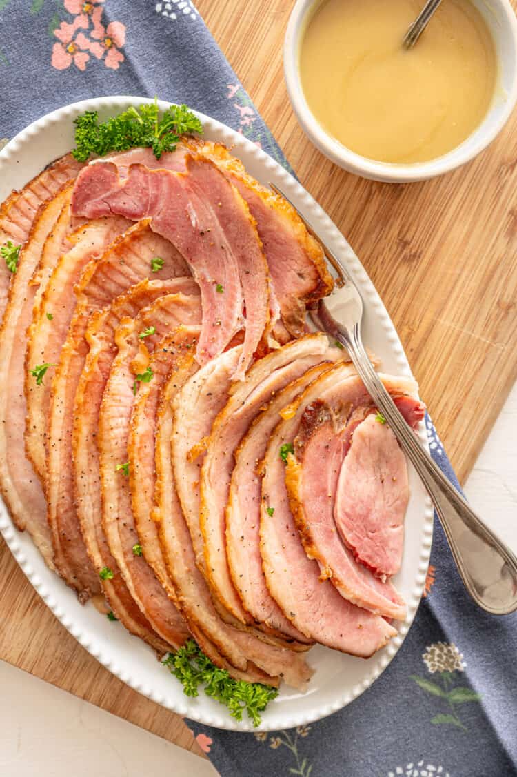 Spiral sliced ham with pineapple sauce drizzled over it.