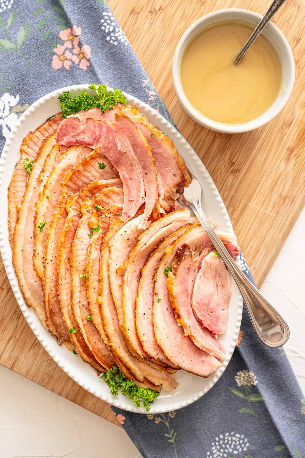 Spiral sliced ham with pineapple sauce drizzled over it.