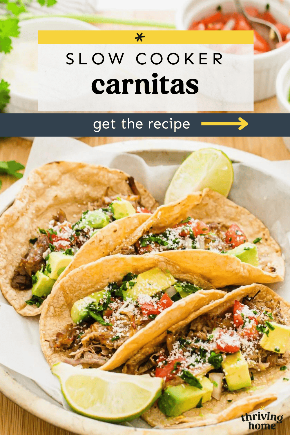 Slow cooker carnitas served on a plate with salsa and lime wedges.