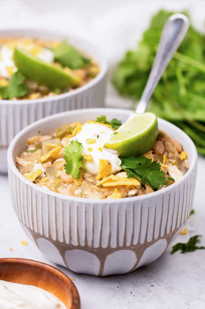 bowl of white chicken chili with toppings