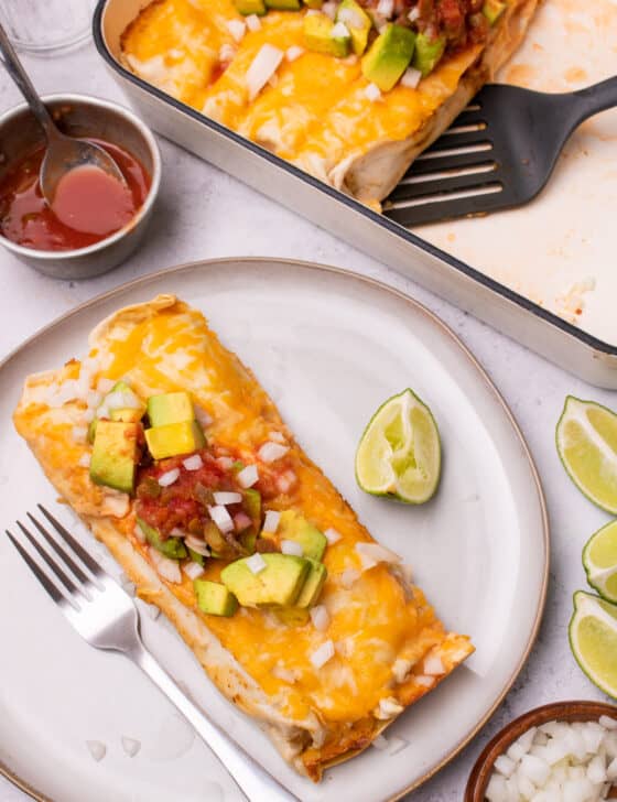 Chicken fajita casserole served on a plate with salsa and avocado on top.