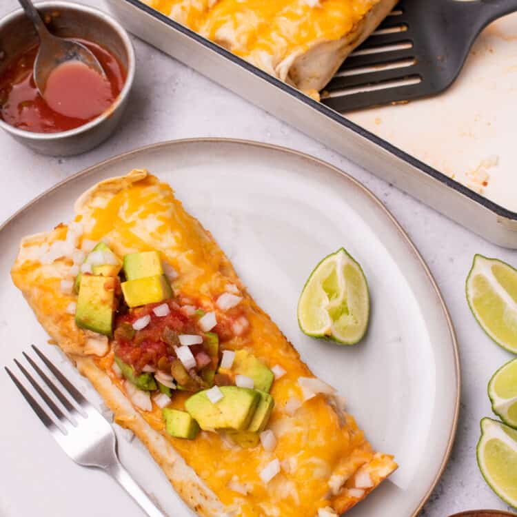 Chicken fajita casserole served on a plate with salsa and avocado on top.