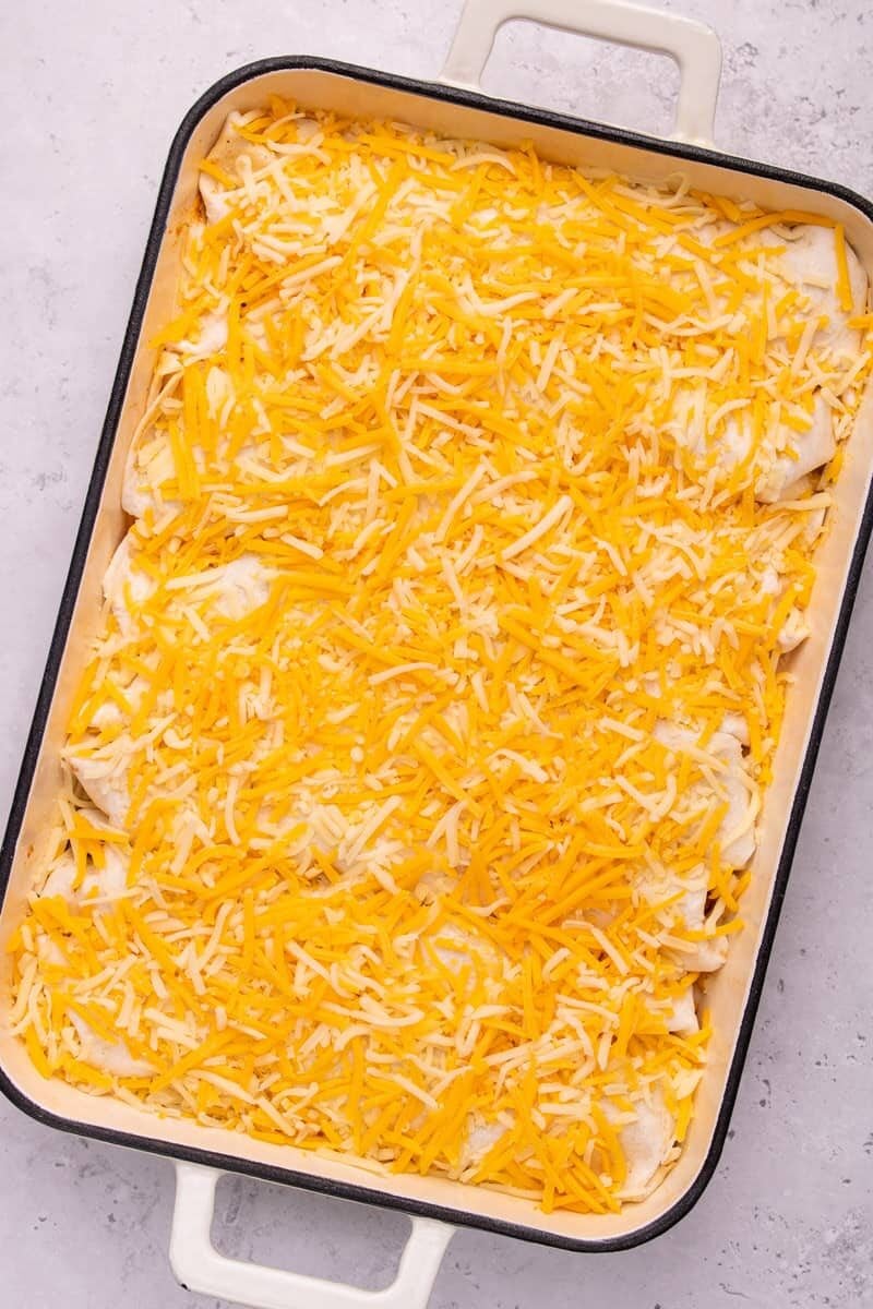 uncooked chicken fajita casserole with cheese on top