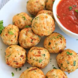 air fryer turkey meatballs on a plate with marinara sauce.