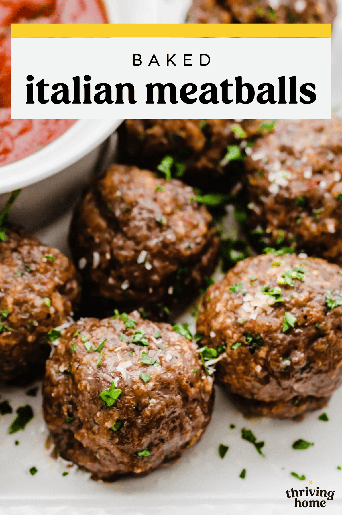Italian baked meatballs with fresh herbs on top.