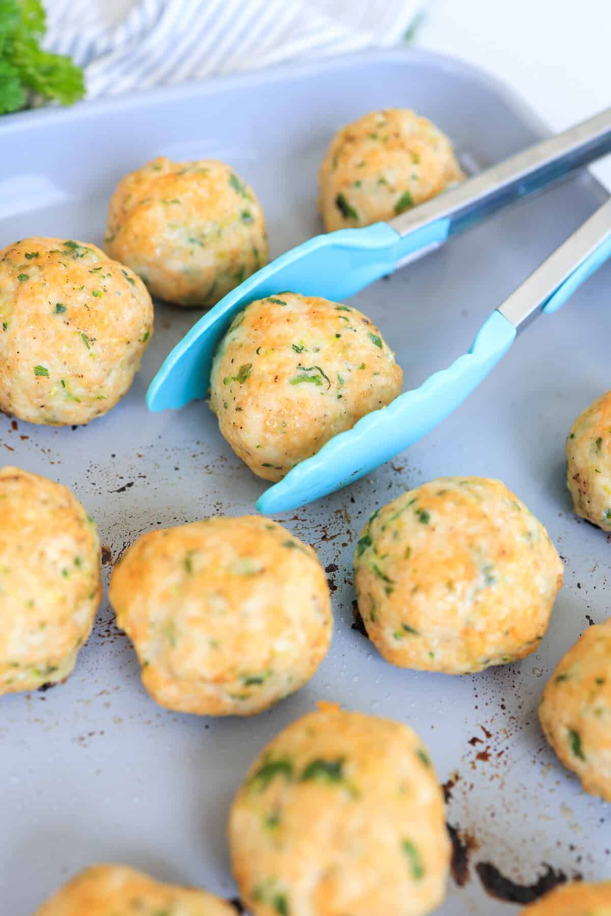turkey meatballs that have been baked on a sheet pan.