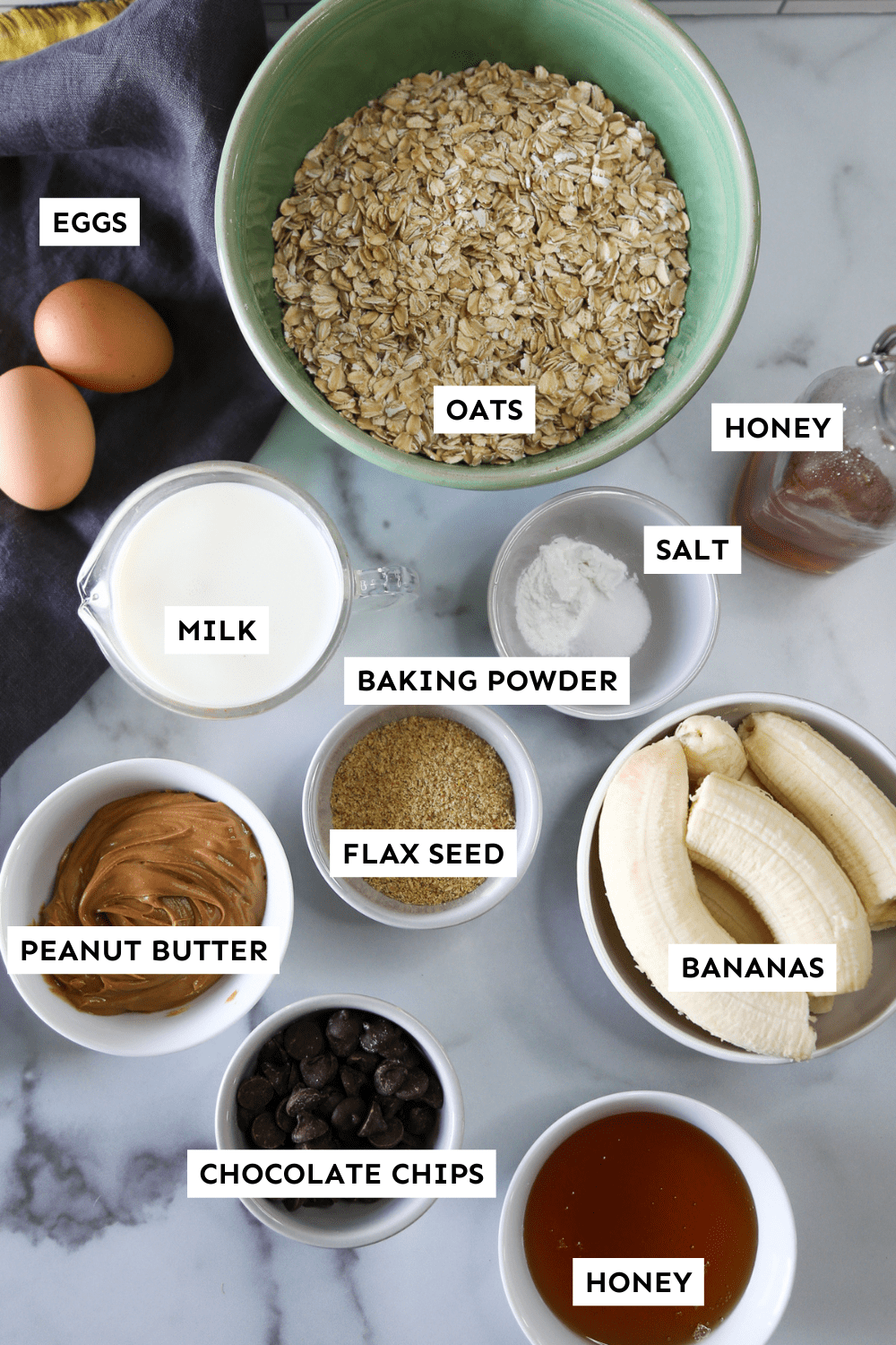 Ingredients for banana baked oatmeal measured in bowls sitting on the counter.