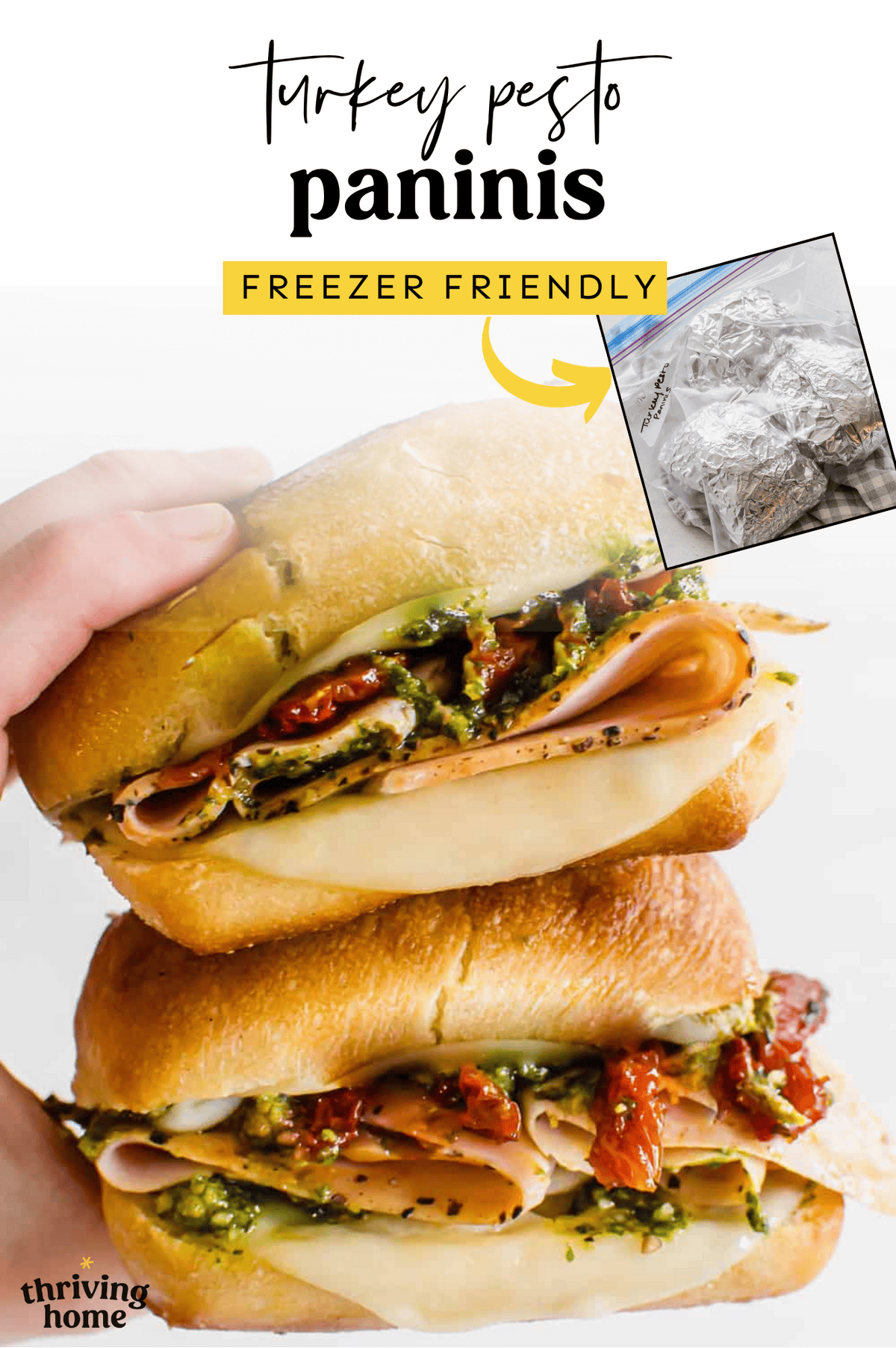 Two turkey pesto paninis being held by a hand.