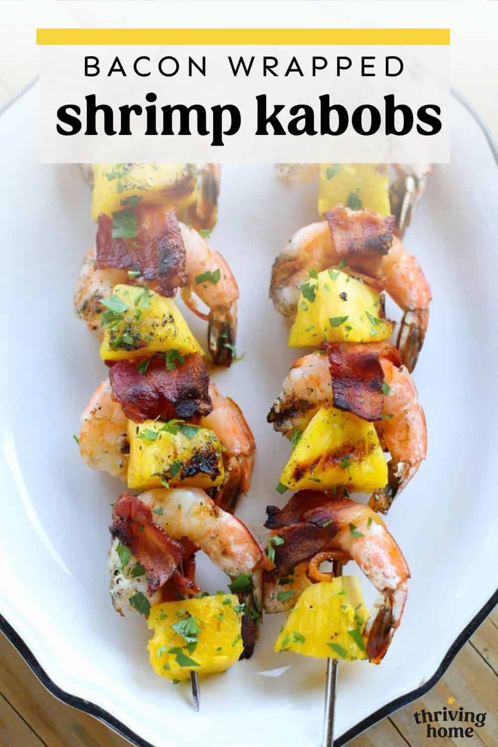 Bacon-wrapped shrimp kabobs on a platter.