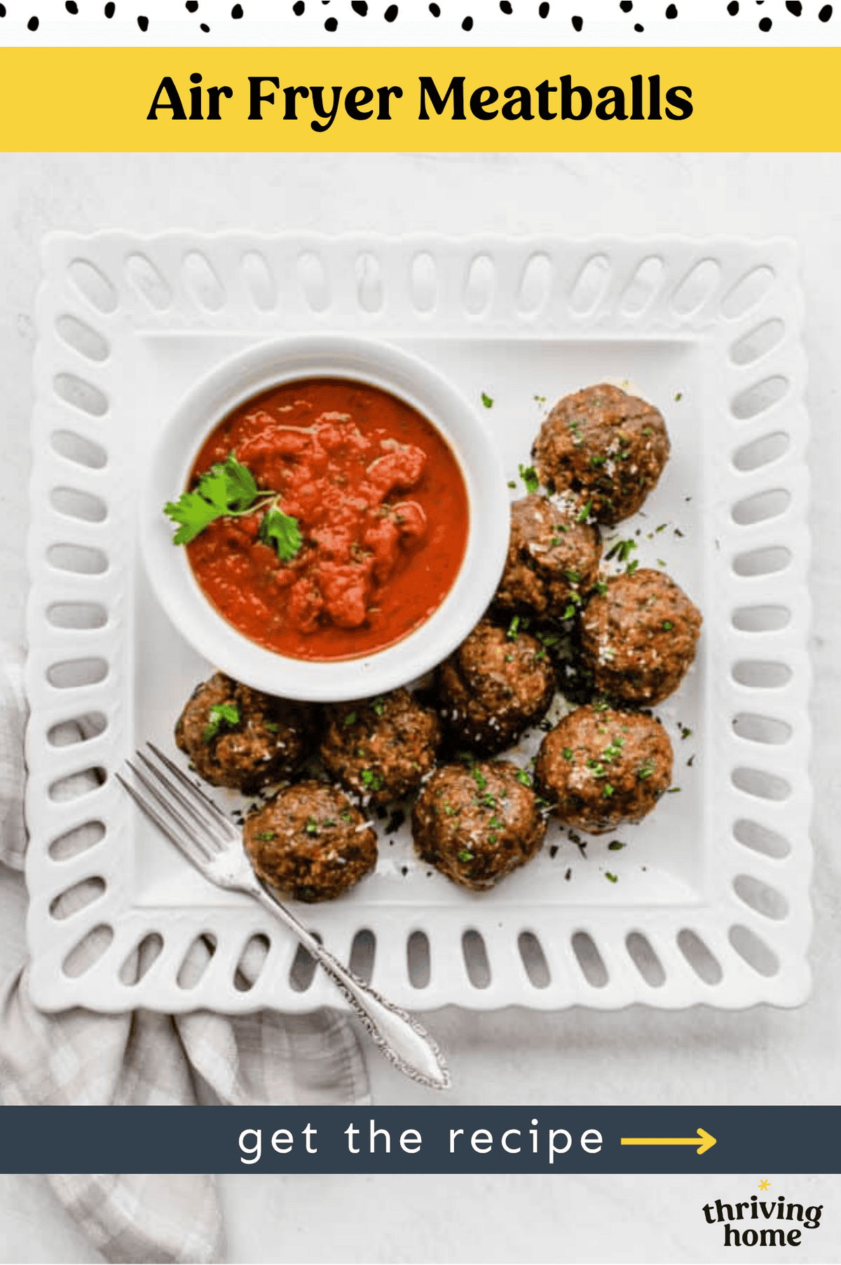 Air fryer meatballs on a white square platter with a bowl of marinara sauce.