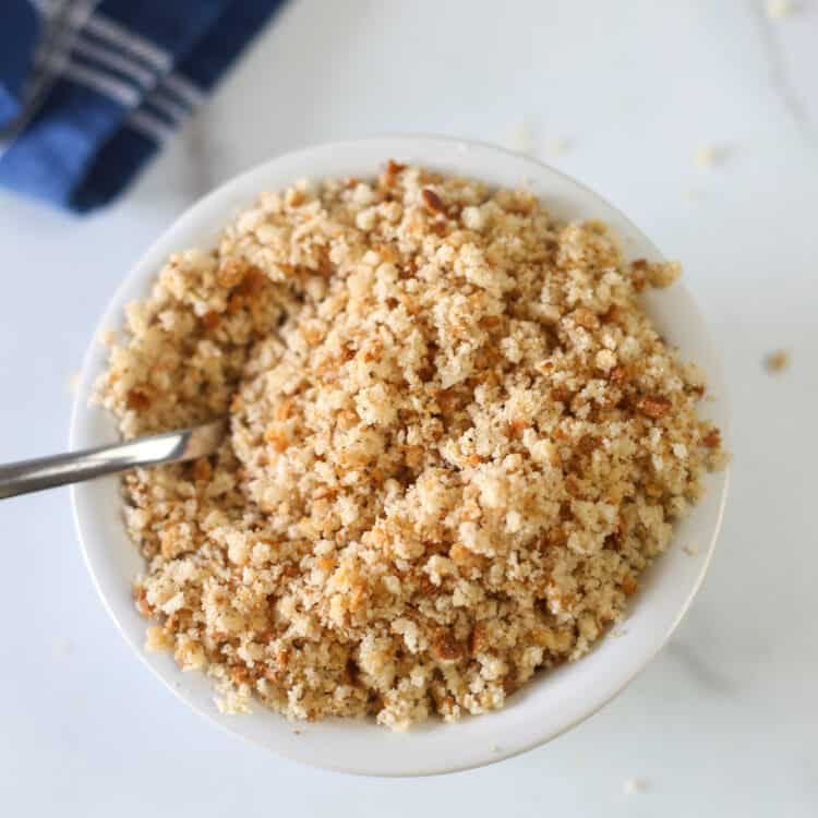 overhead shot of gluten free breadcrumbs in a bowl with a spoon