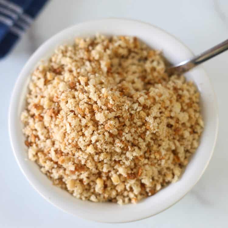 a bowl of gf bread crumbs with a spoon
