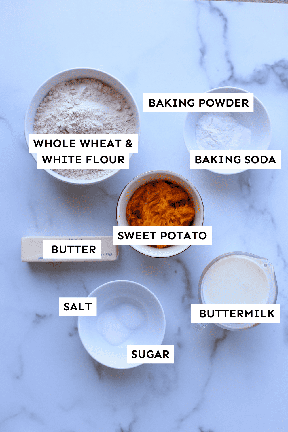 Ingredients for sweet potato biscuits measured in bowls and labeled.