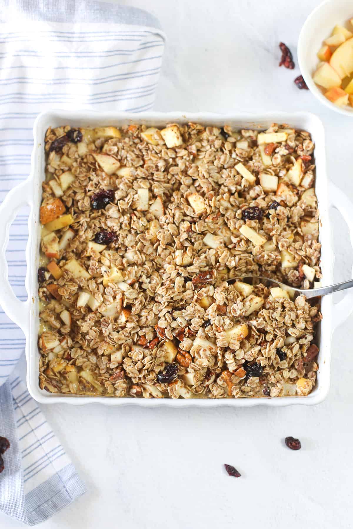 Mixed fruit baked oatmeal in a white casserole dish ready to serve.