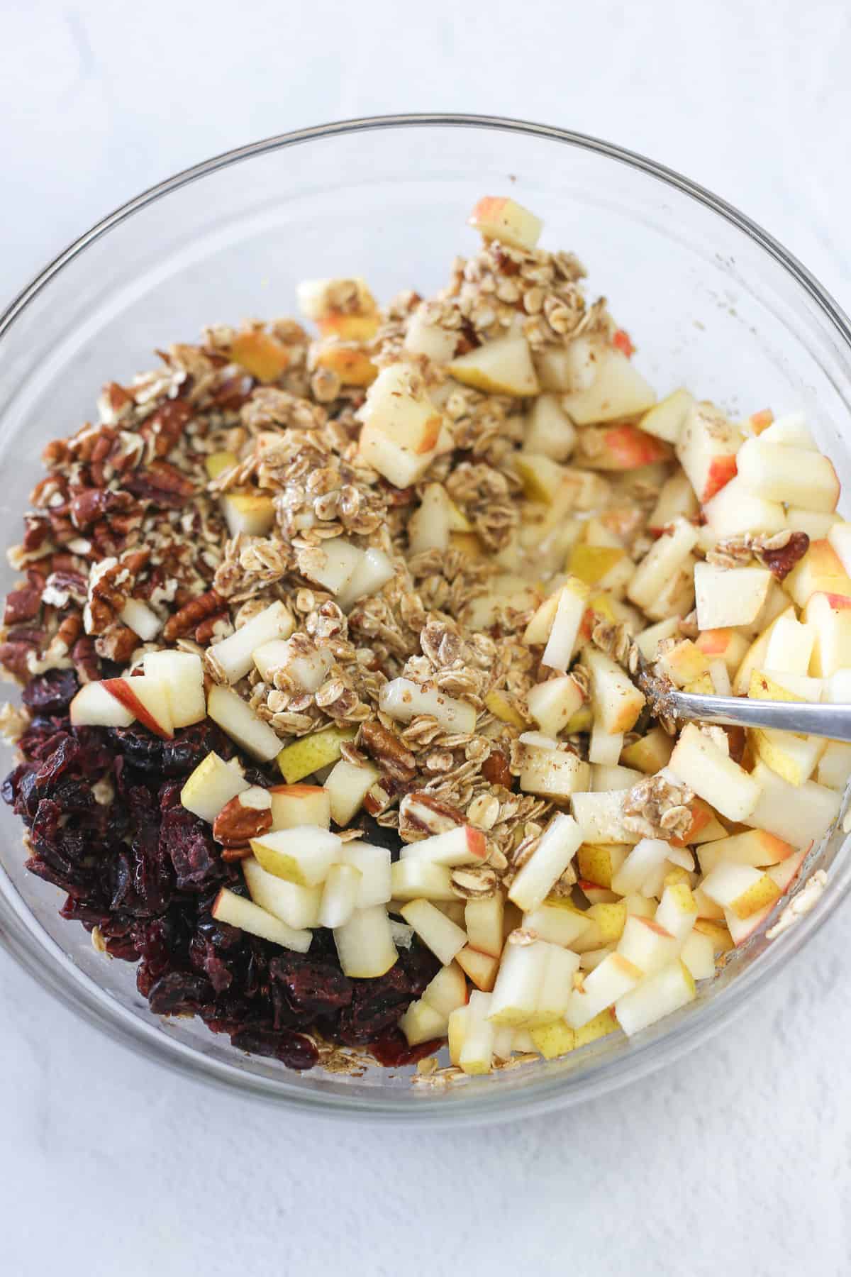 Mixing fruit into the baked oatmeal mixture.