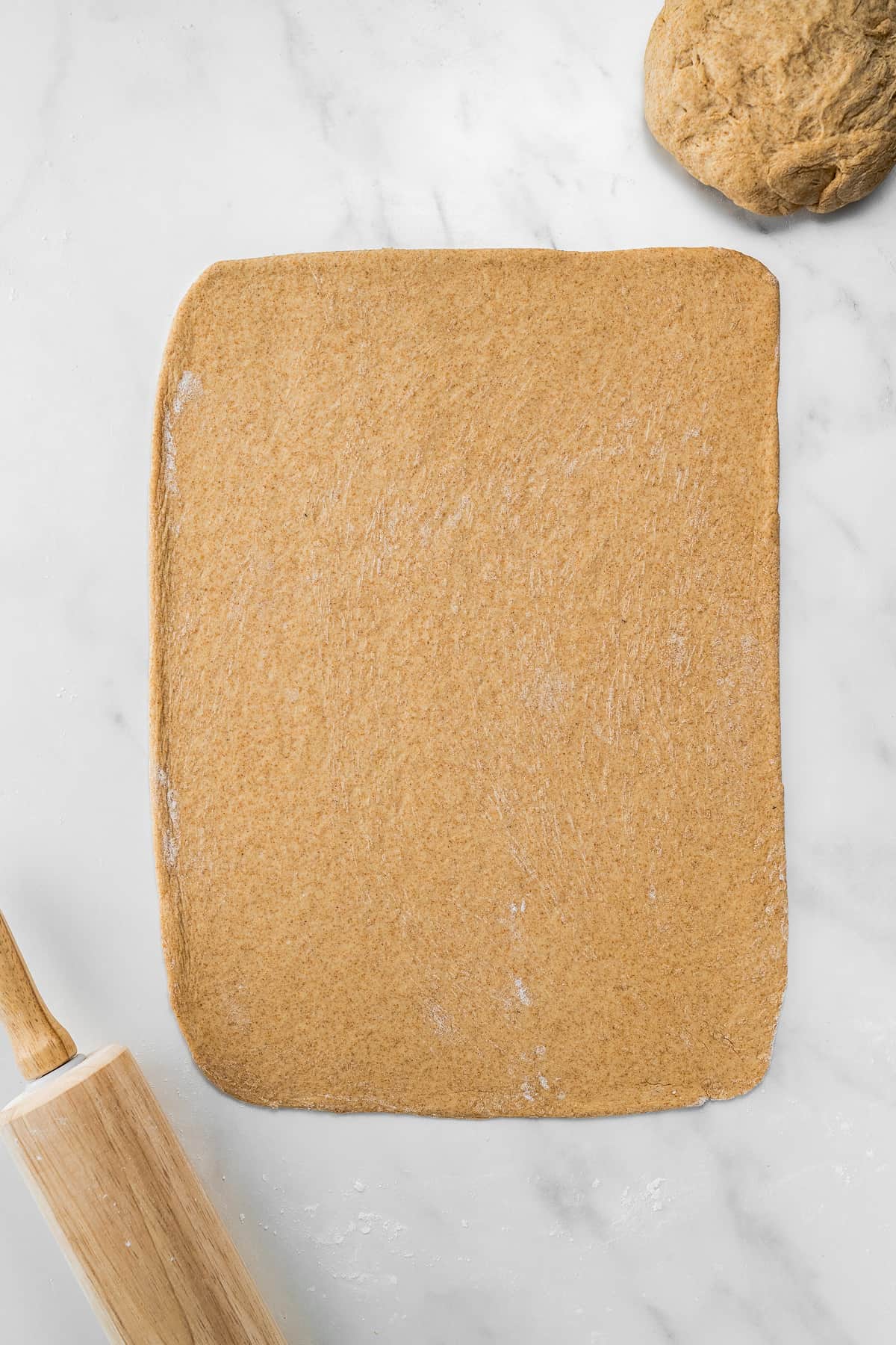 Rolled out pizza dough in a rectangle for stromboli pizza.