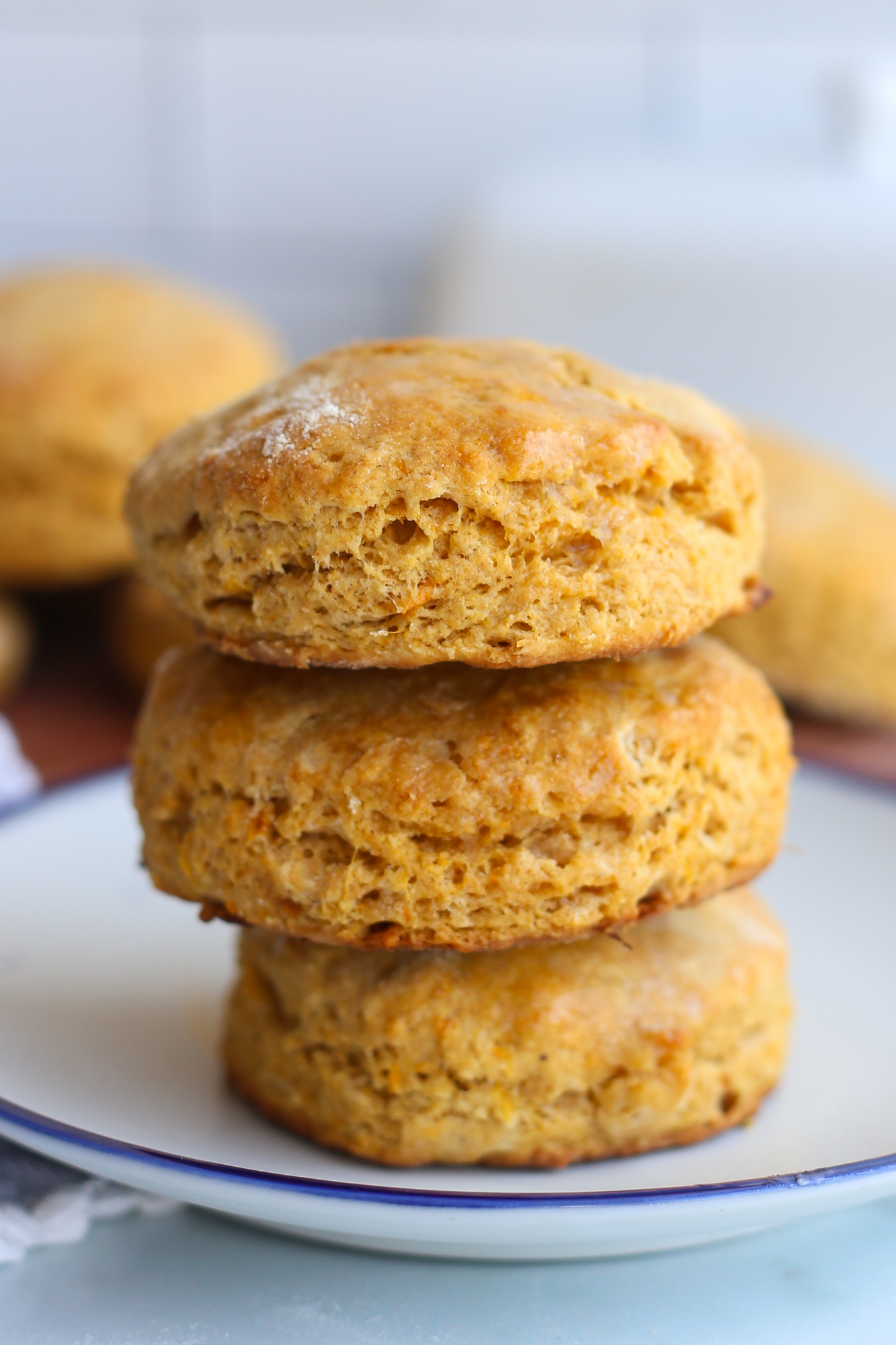 Three sweet potato biscuits stacked on a plate.