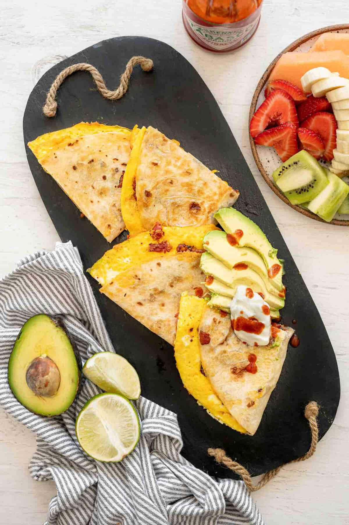 Cut up Breakfast Quesadilla with sliced avocado.