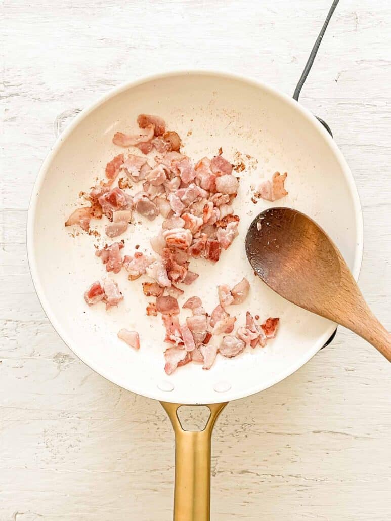 Bacon pieces cooking in pan for Breakfast Quesadilla