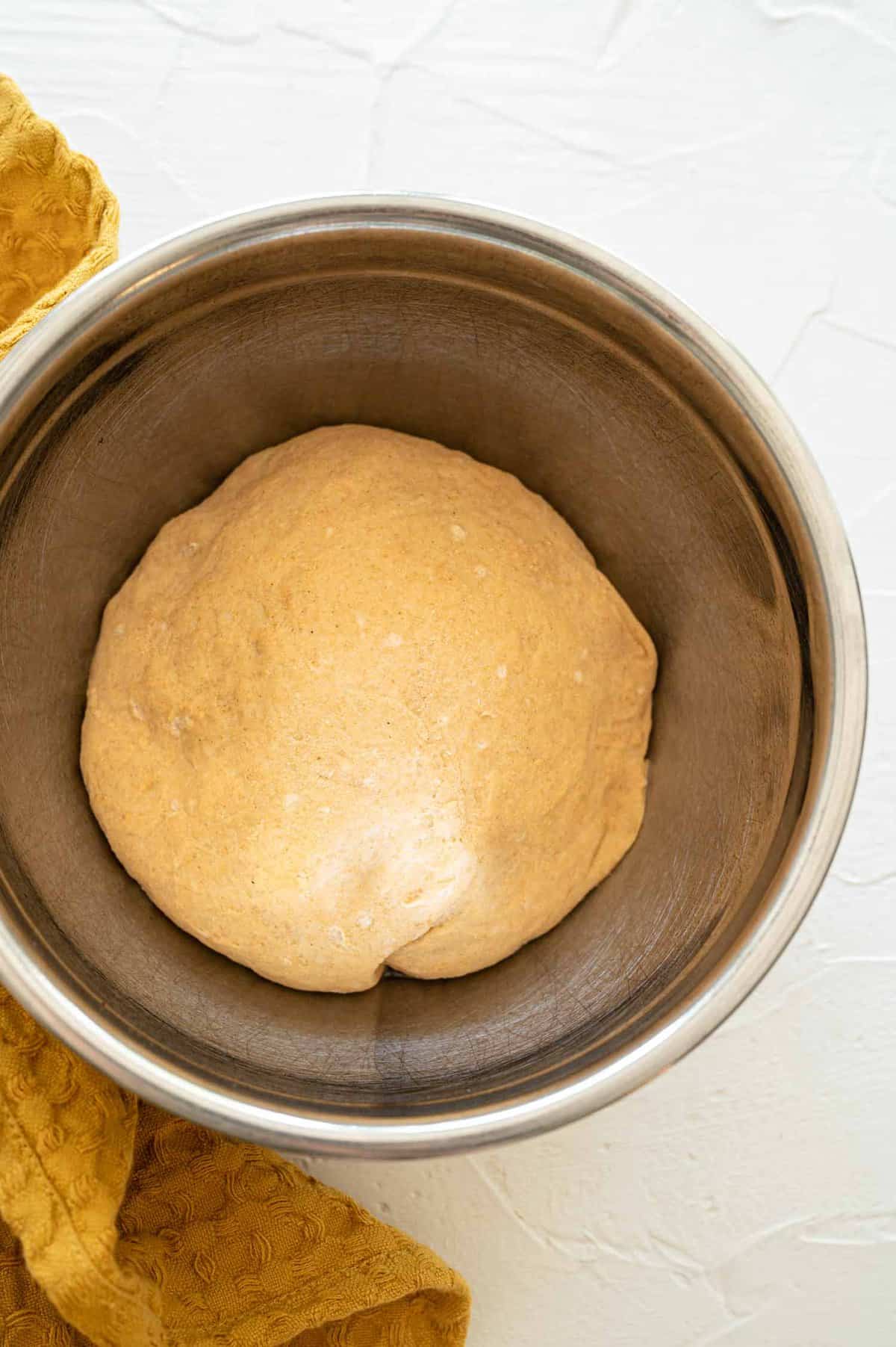 a calzone or pizza dough ball that has risen in a bowl