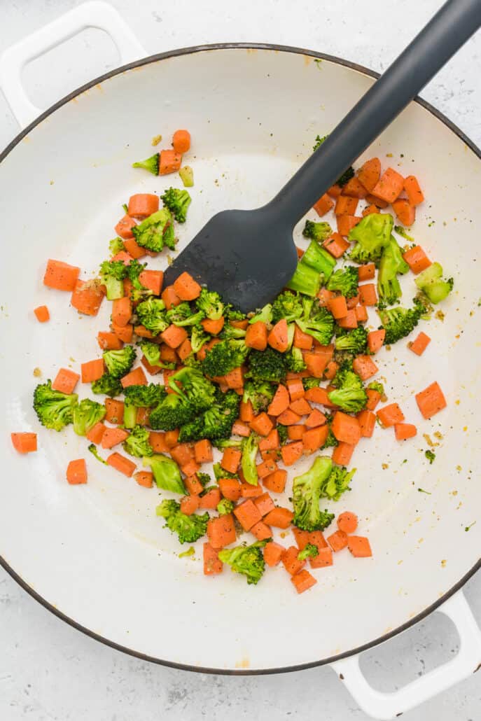 carrots and broccoli sauteing in skillet for egg fried rice