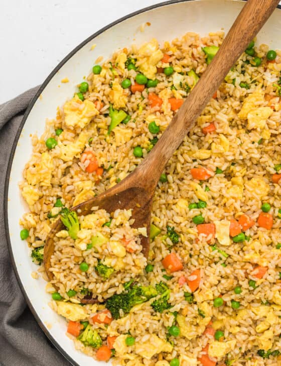 skillet of eegg fried rice with wooden spoon