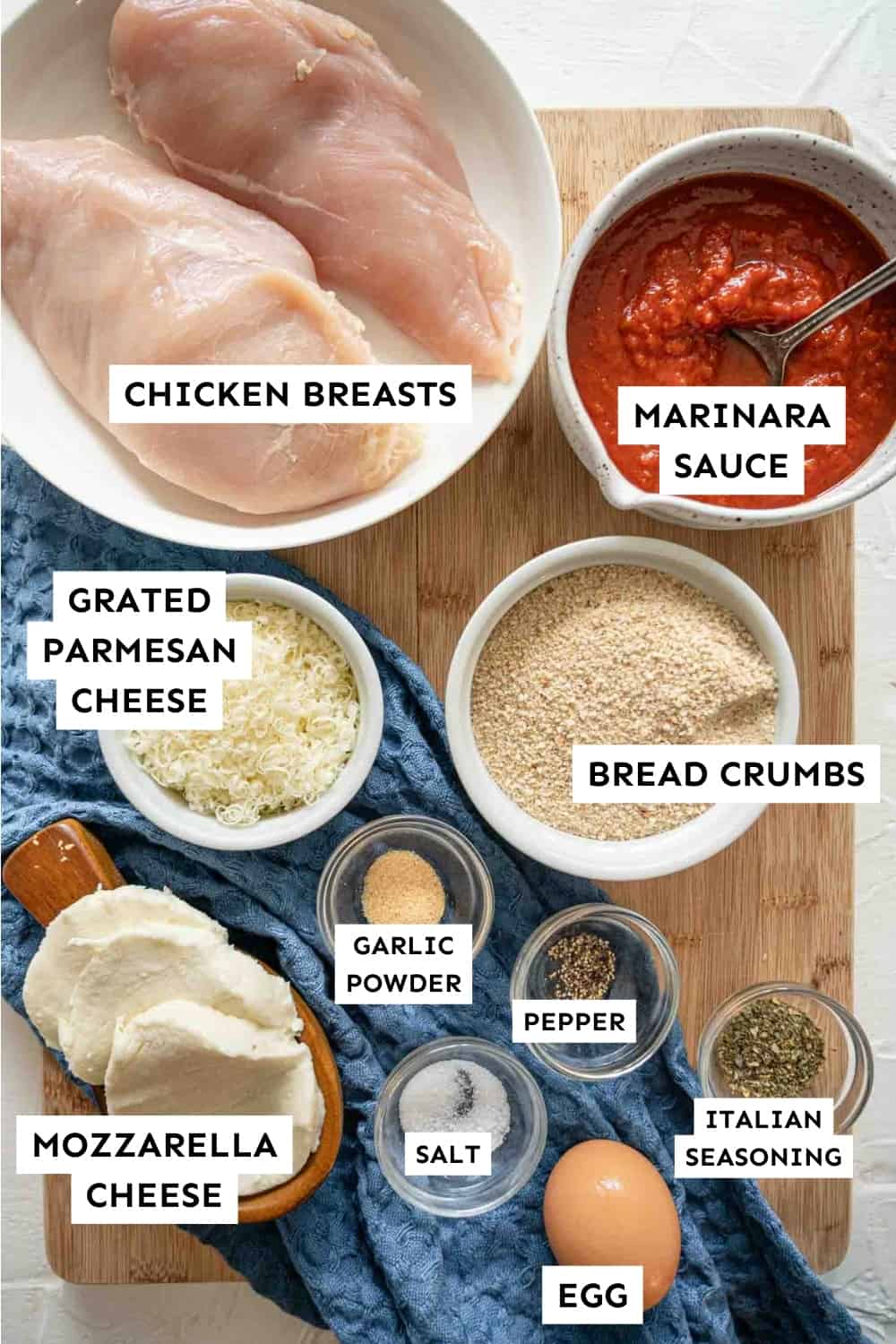 Ingredients laid out and labeled for Baked Chicken Parmesan.