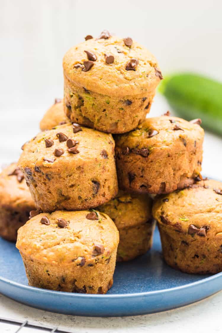 Chocolate Chip Zucchini Muffins stacked on a plate.