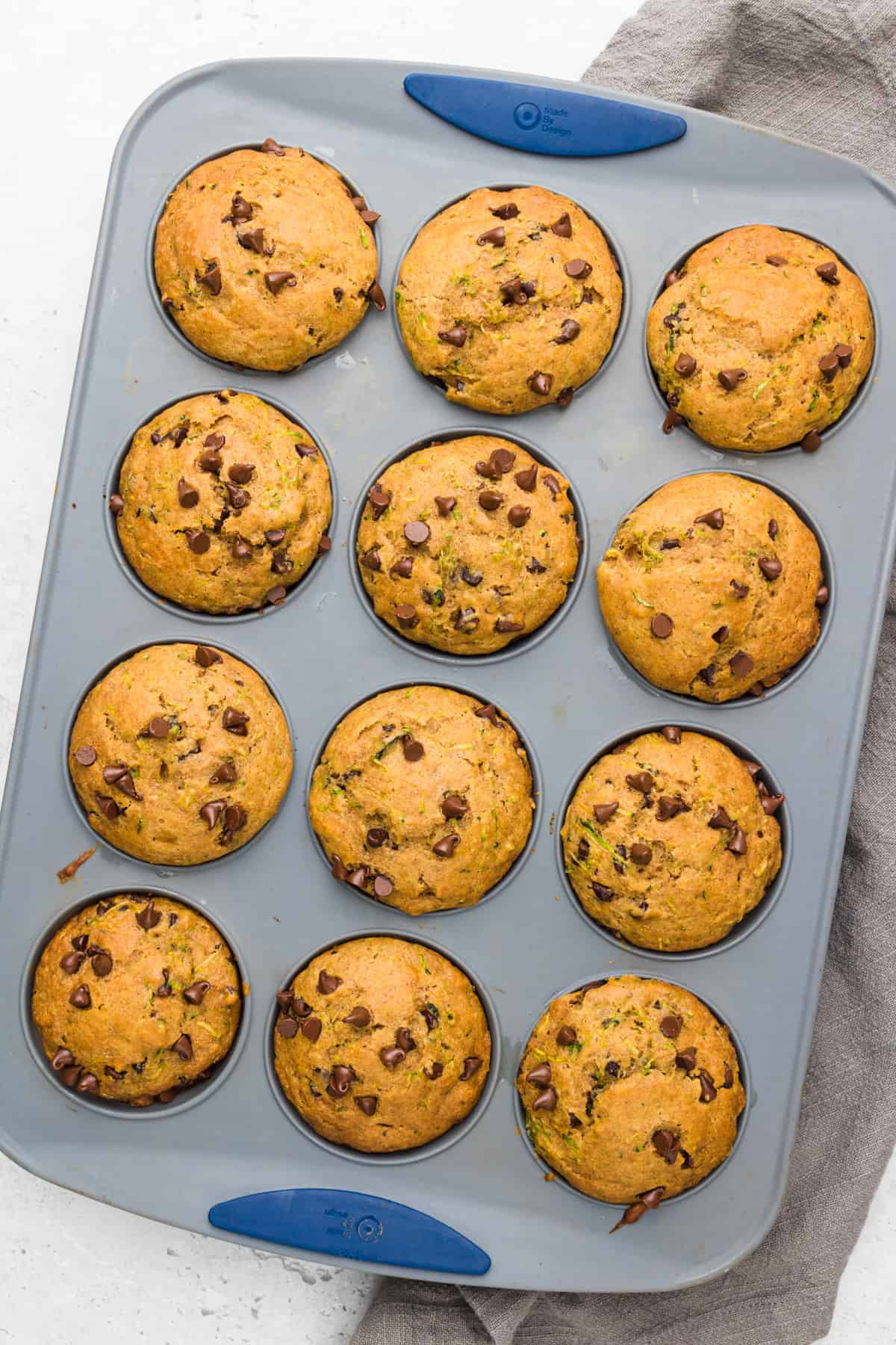 Chocolate Chip Zucchini Muffins in a muffin pan fresh from the oven.