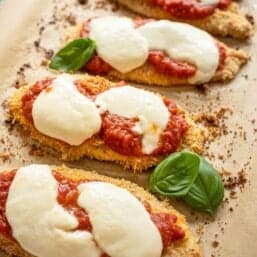 Baked Chicken Parmesan fresh from oven with fresh mozzarella slices melted over it