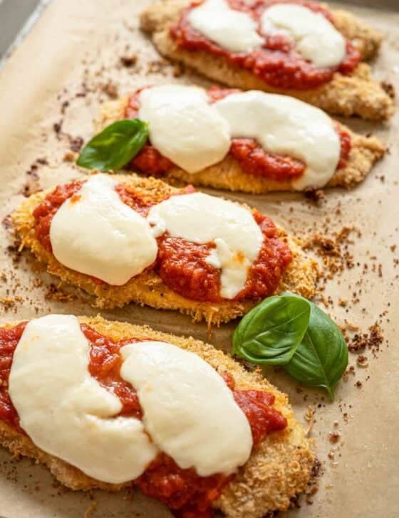 Baked Chicken Parmesan fresh from oven with fresh mozzarella slices melted over it