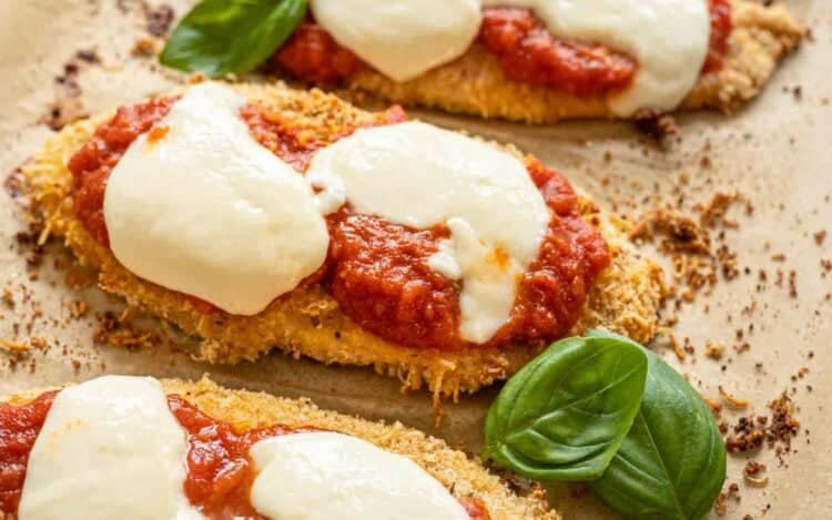 Baked Chicken Parmesan fresh from oven with fresh mozzarella slices melted over it