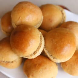 Bread machine hamburger buns on a plate to serve.