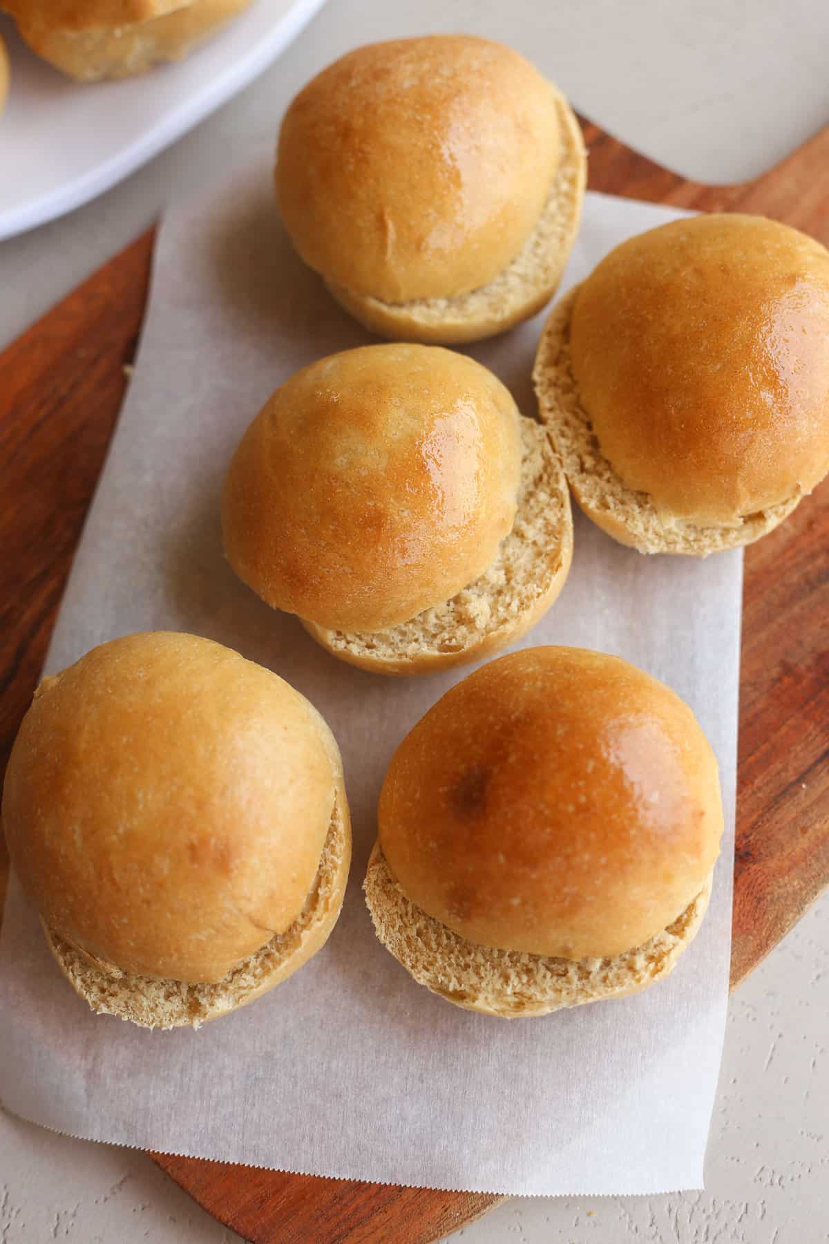 Whole wheat hamburger buns sliced and ready to use.